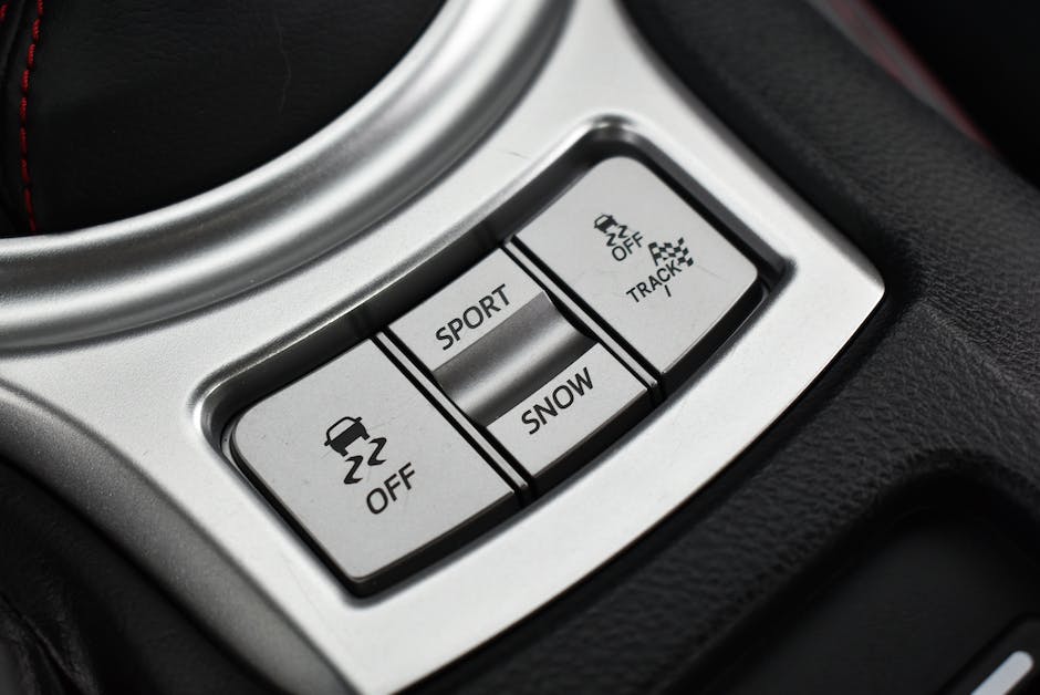 The image shows the dashboard of a GMC Terrain with various control buttons and a touchscreen display.