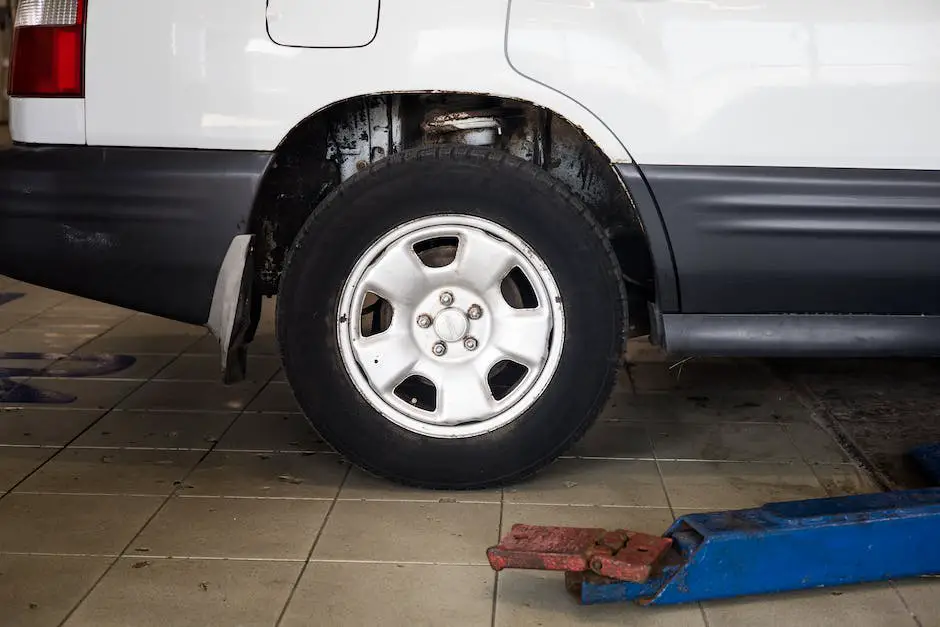 A car being lifted on a hydraulic car jack with a mechanic's hand holding a flashlight to inspect the underside of the car.